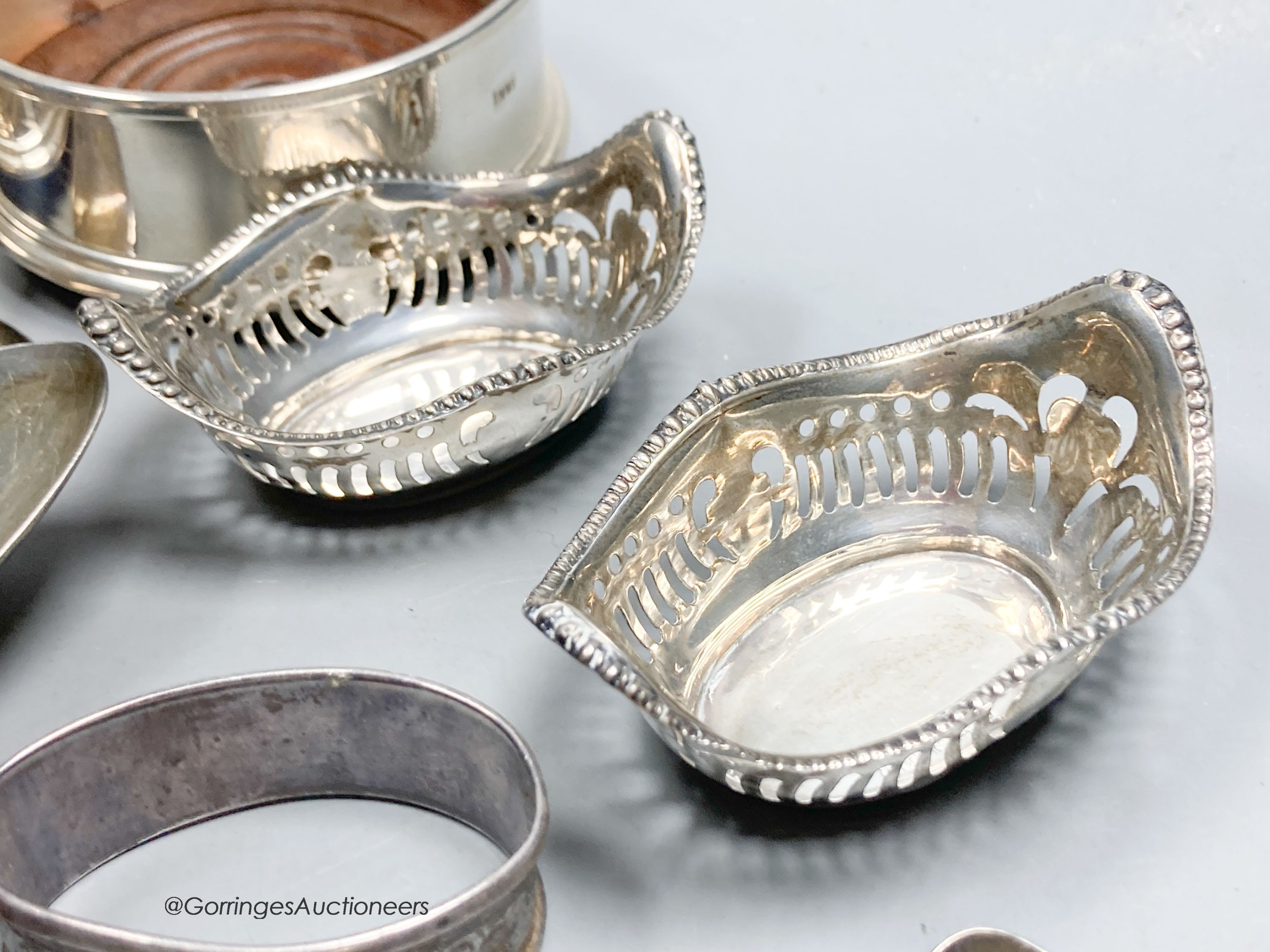 A pair of George III silver tablespoons, a pair of modern silver bottle coasters, a pair of pierced silver bon bon dishes, six silver teaspoons and 6 silver coffee spoons.